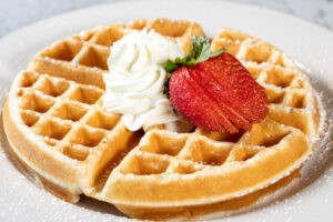waffle with whipped cream and strawberry